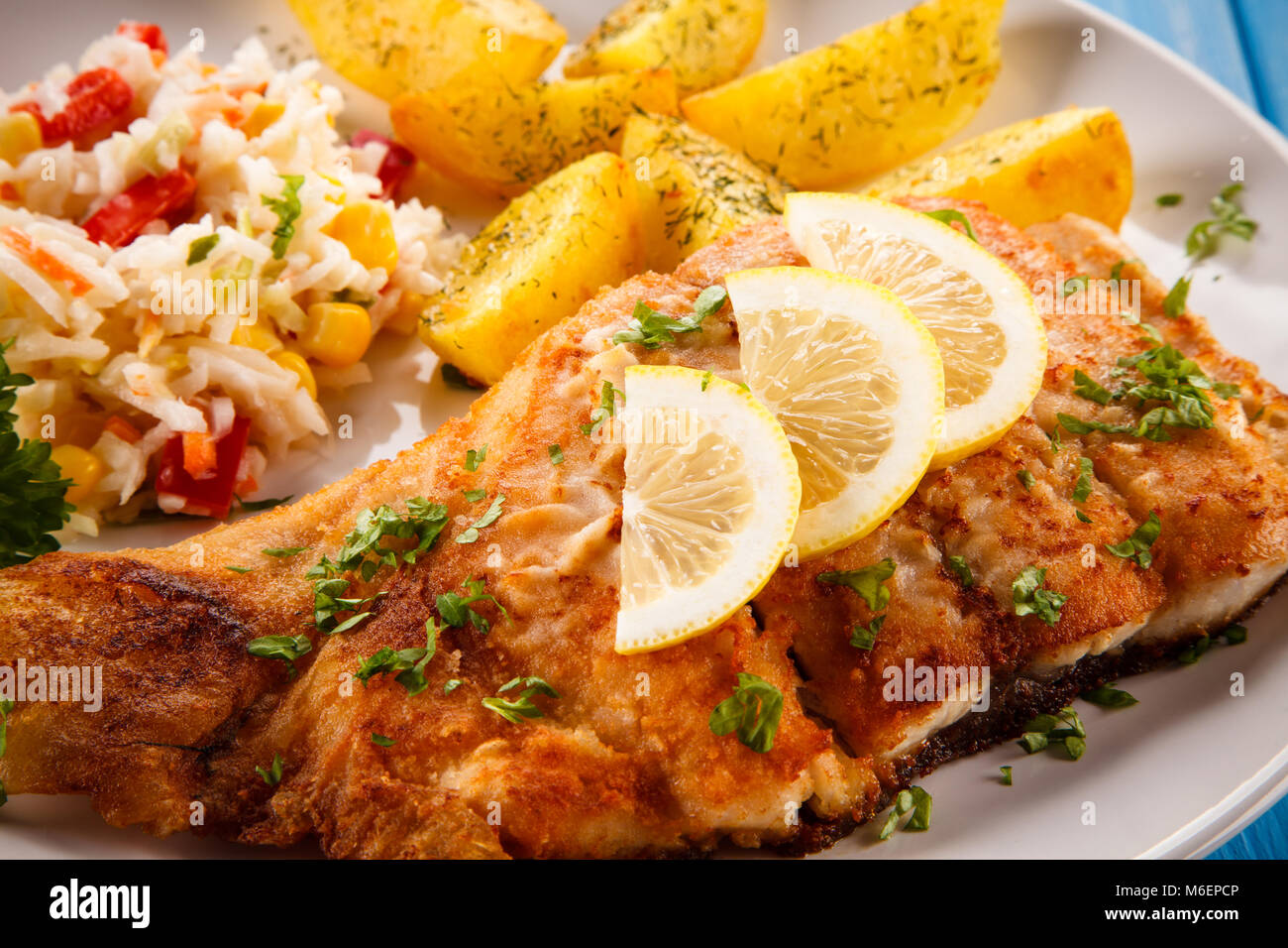 Fish dish - fried fish with potatoes Stock Photo