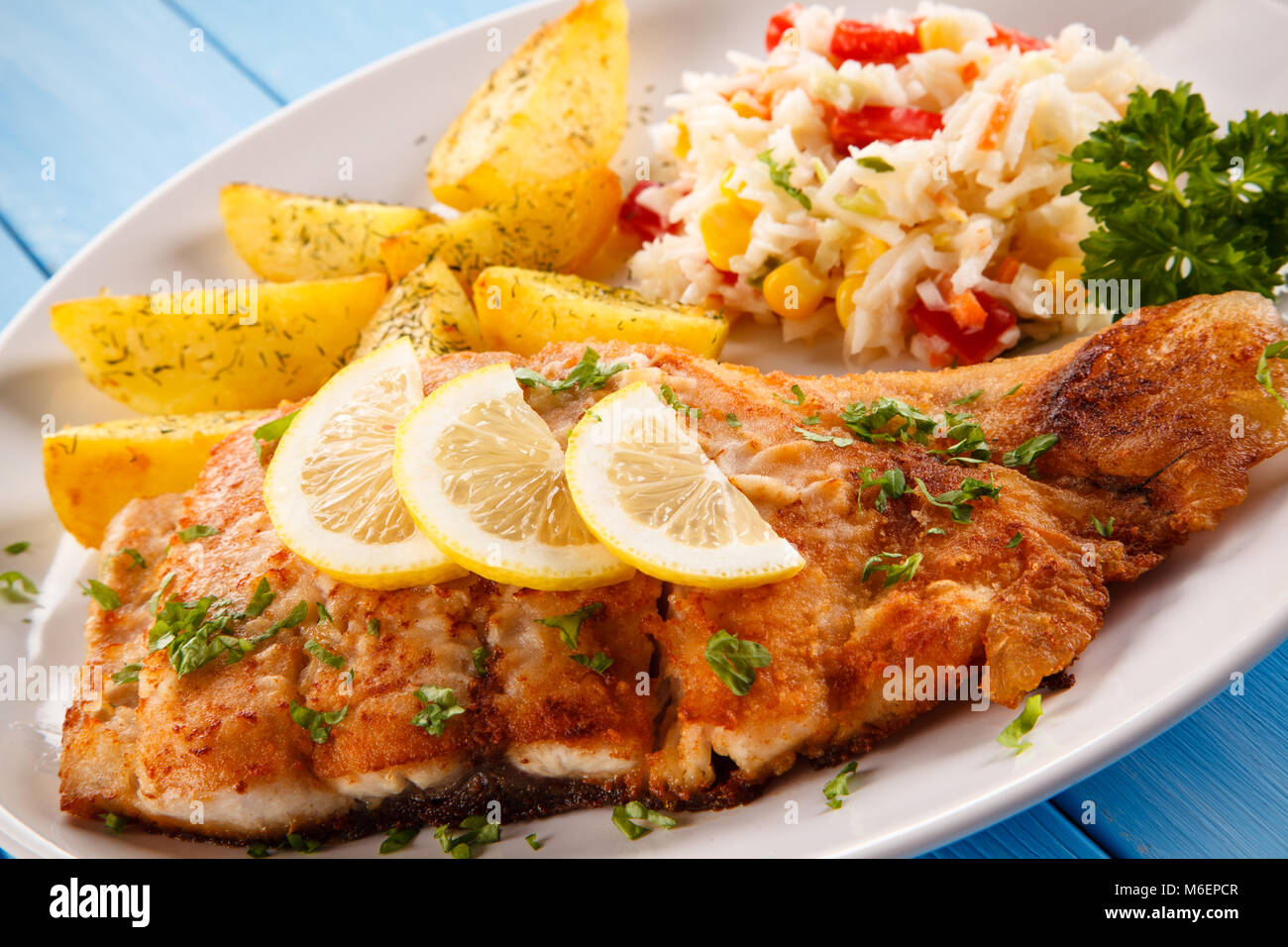 Fish dish fried fish with potatoes Stock Photo Alamy