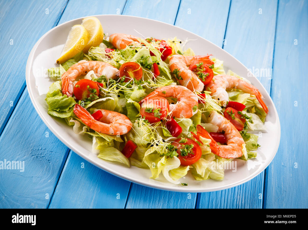 Salad with shrimps on wooden table Stock Photo