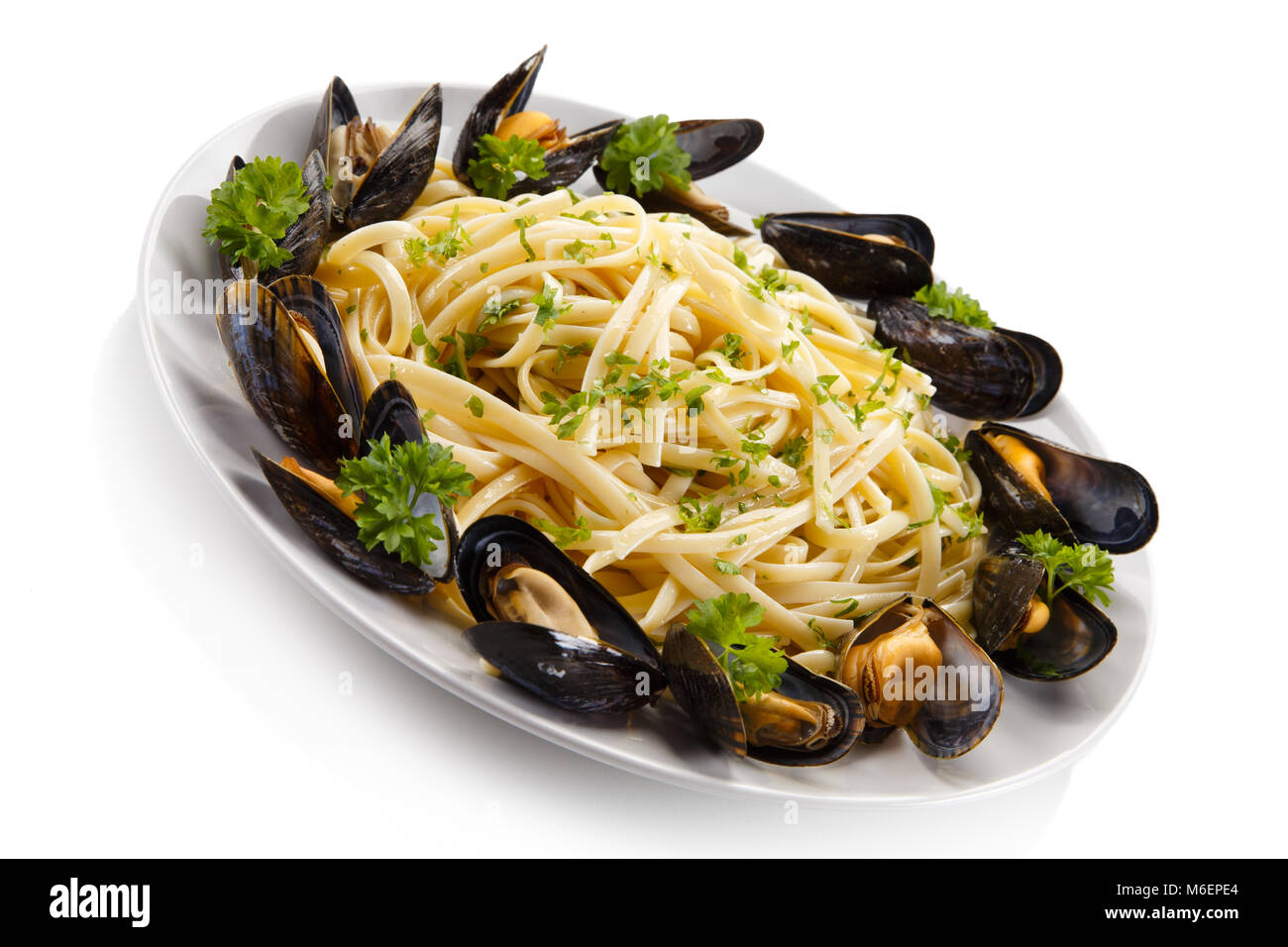 Cooked mussels and pasta on white background Stock Photo