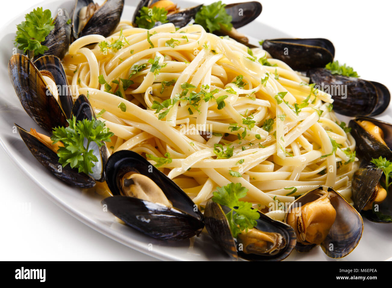 Cooked mussels and pasta on white background Stock Photo