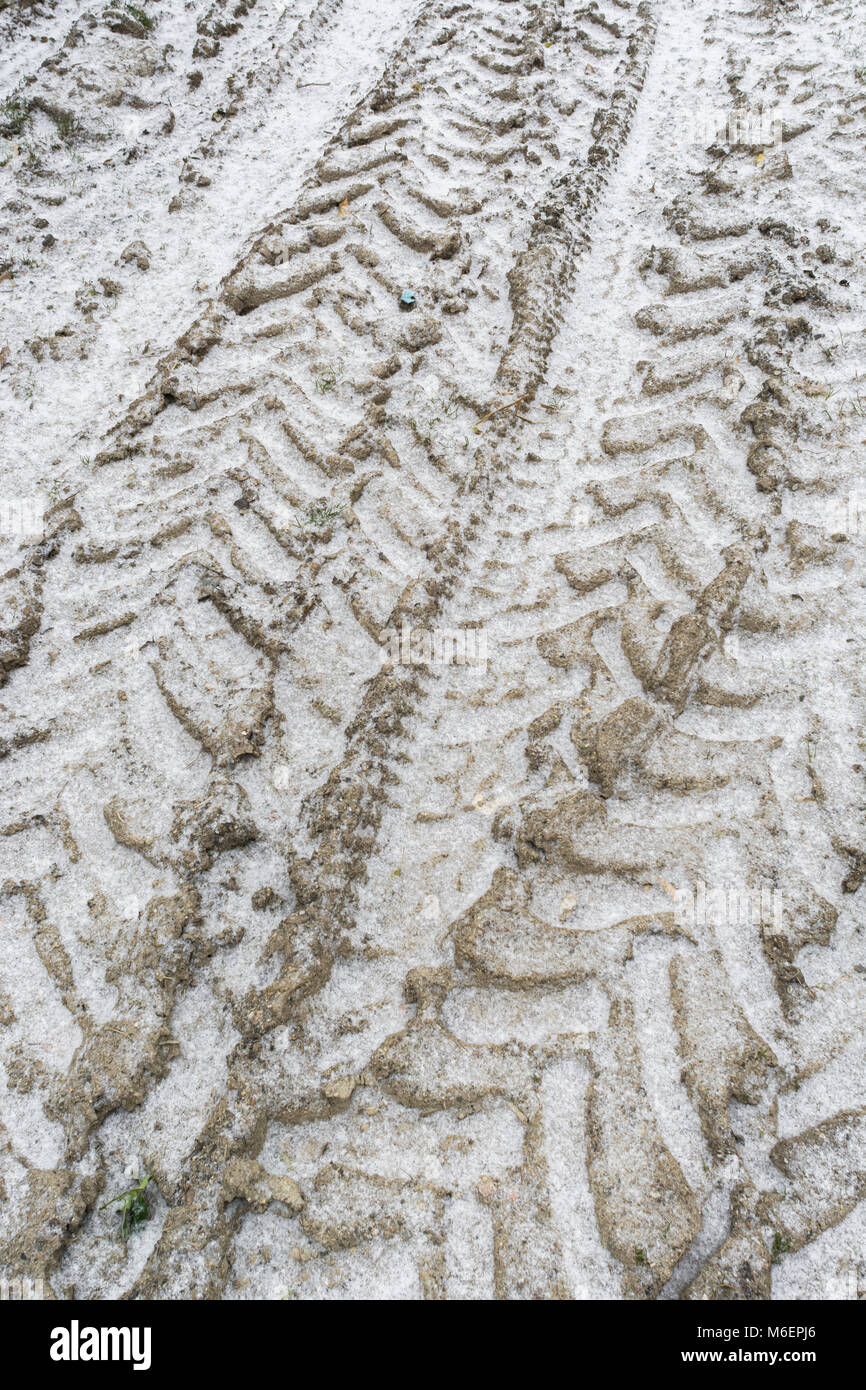 Snow covered tractor tyre tracks during 'Beast from the East' - potential for disrupting farming and agriculture. Stock Photo