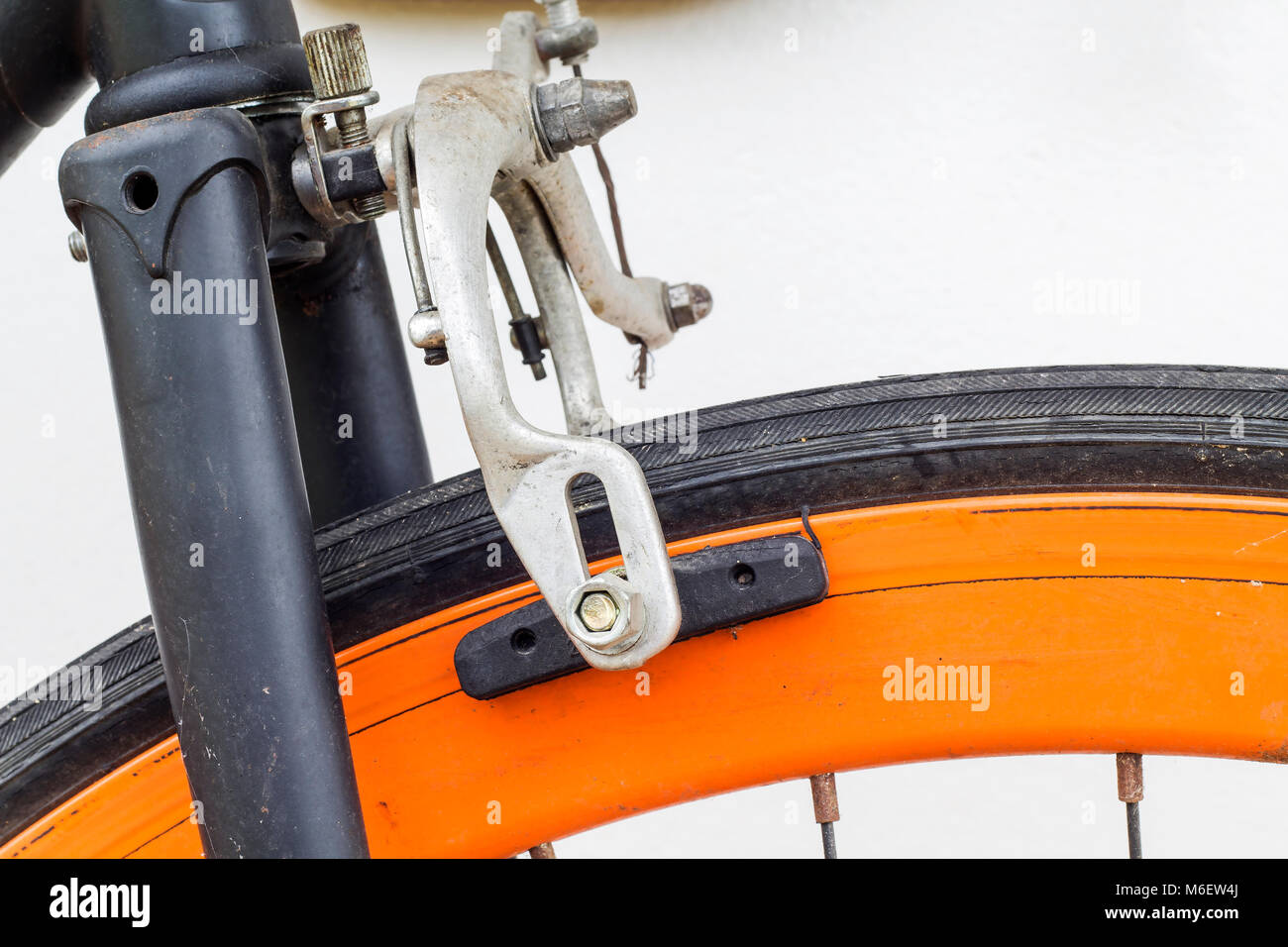 Some of old bicycle brakes on white wall. Stock Photo