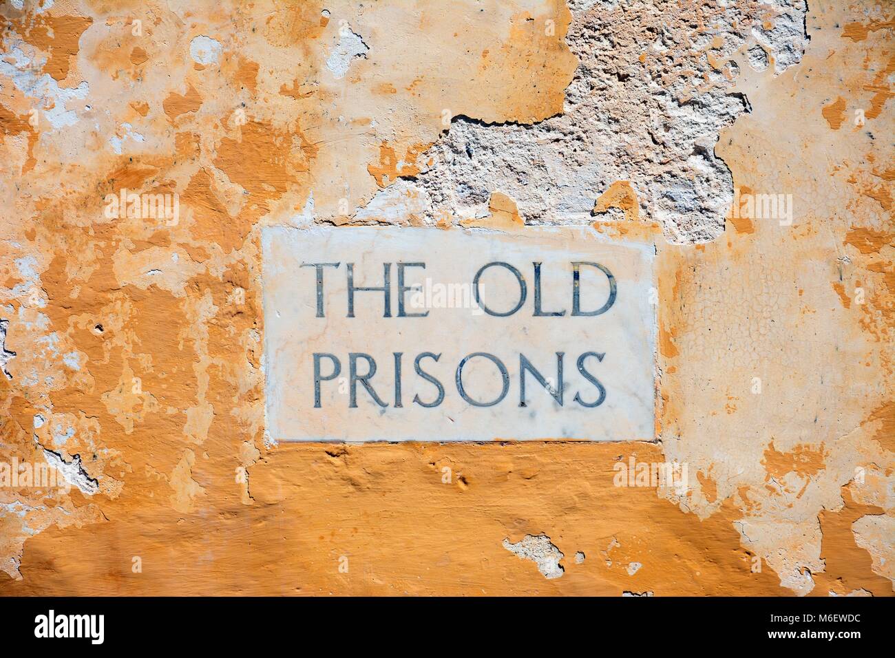 The Old Prisons sign embedded in a building wall within the citadel, Victoria (Rabat), Gozo, Malta, Europe. Stock Photo
