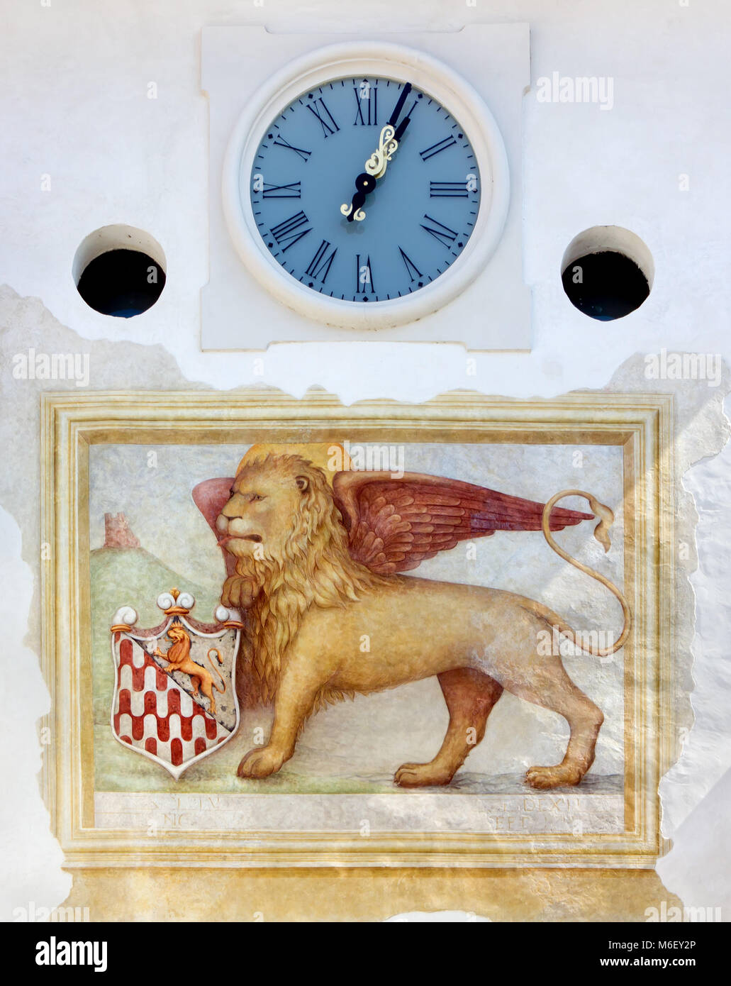 Venetian Winged Lion Fresco and Clock on West Tower Town Gate in Spilimbergo, Italy Stock Photo