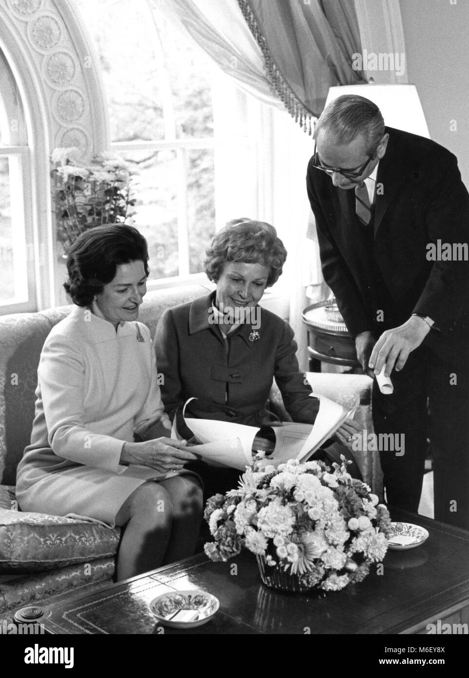 Mrs Pat Nixon (center), wife of president-elect Richard M Nixon, goes over White House floor plans with Mrs Lyndon Johnson (left) and unnamed official, Washington, DC, 11/11/1968. Stock Photo