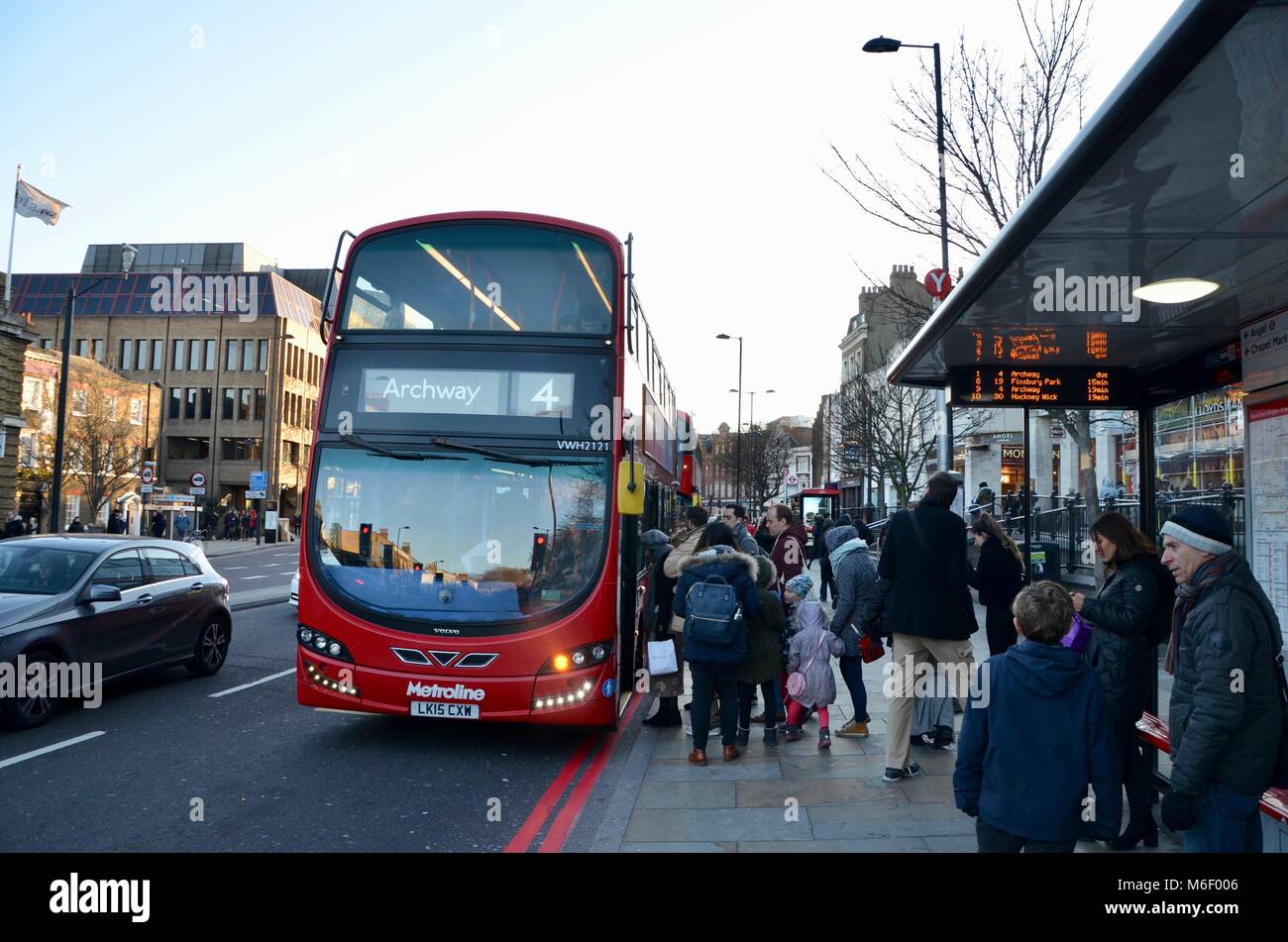 the number 4 london bus to archway picking up passengers in angel north londin UK Stock Photo