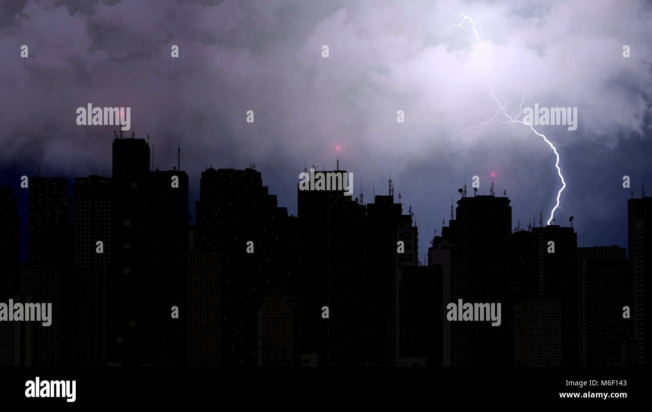 Big city skyline illuminated with flashing light, clouds above city  skyscrapers Stock Photo - Alamy