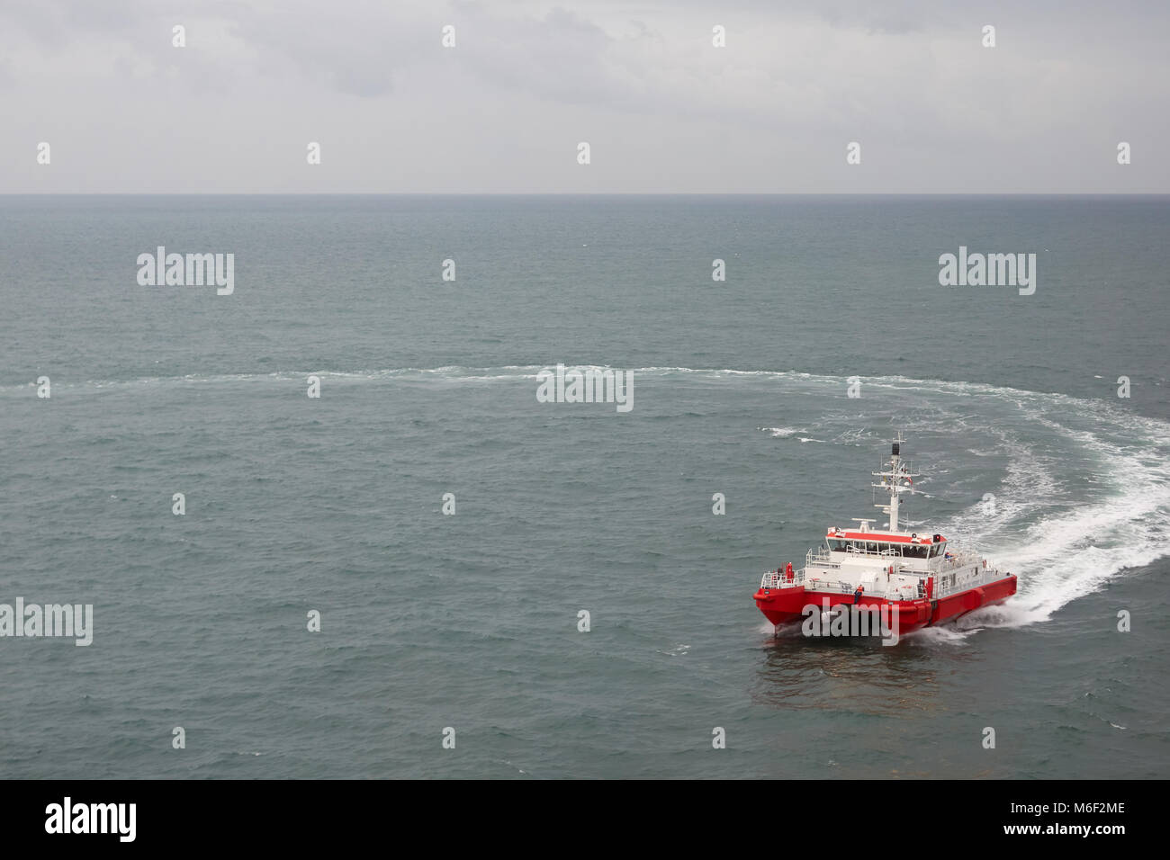 Modern tugboat of red and white color in the sea. Stock Photo