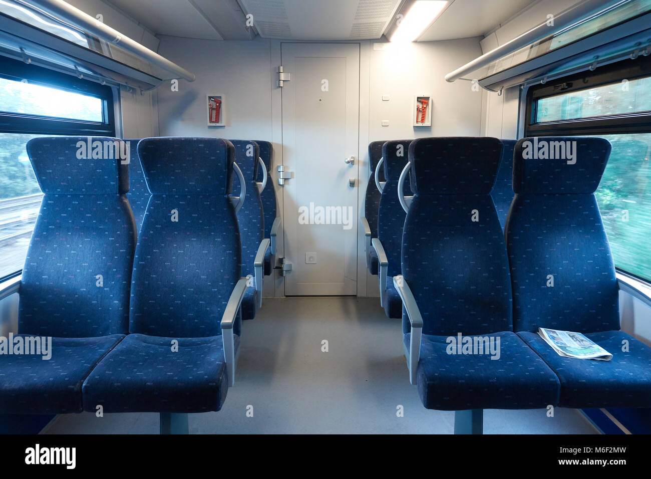 Salon of a modern train without people. On the armchair lies the news paper. Stock Photo