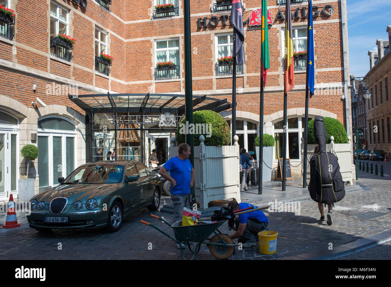 Bruxelles, worker looks at a passerby with low contrabass. Belgium. Stock Photo