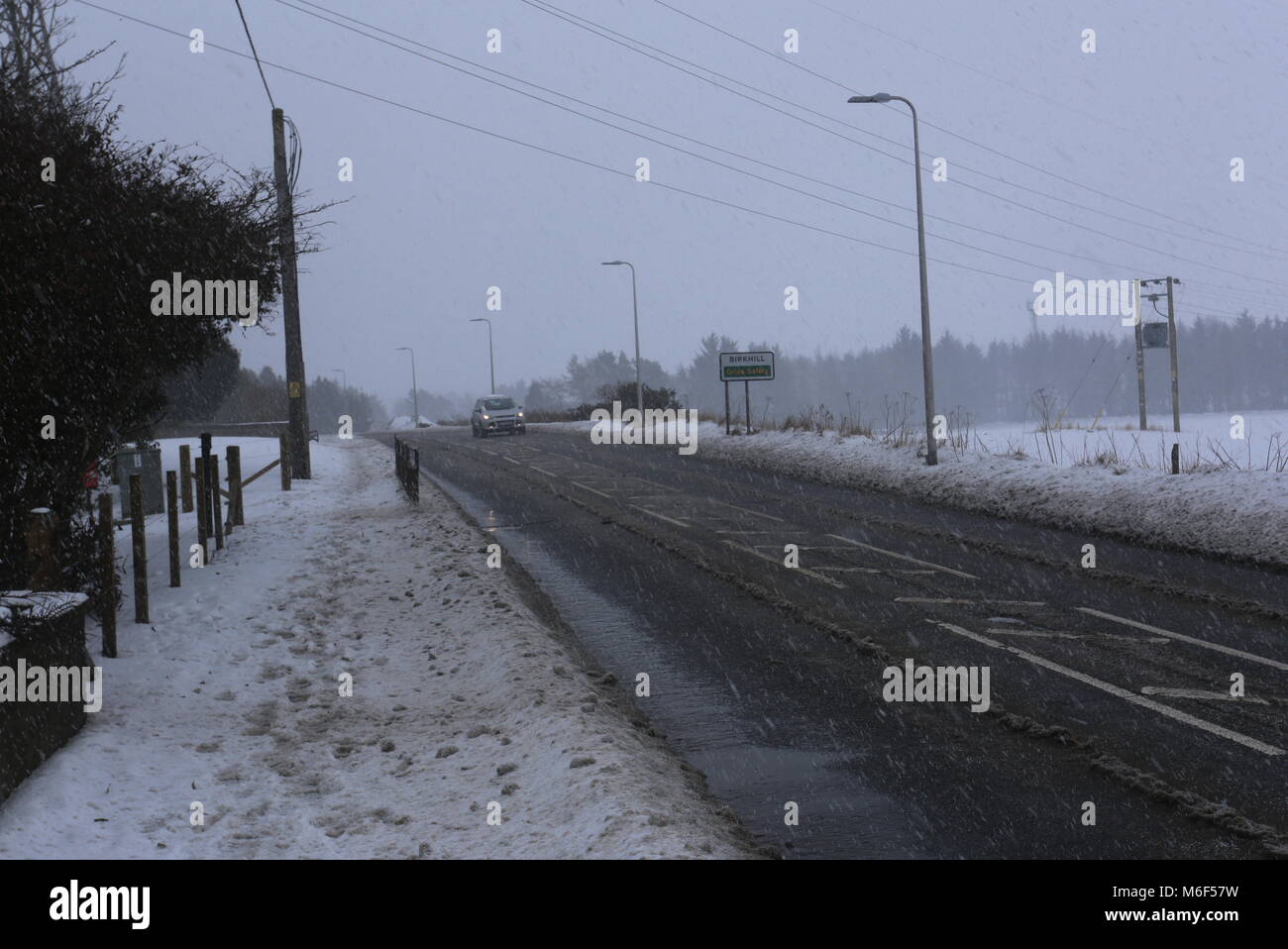 A923 through Birkhill with falling snow Angus Scotland March 2018 Stock
