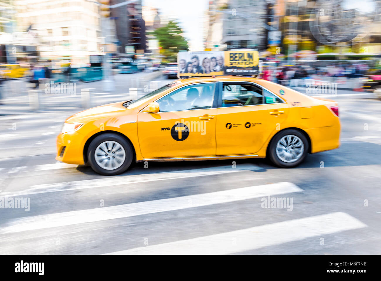 New York City, USA - October 28, 2017: Midtown Manhattan Columbus Circle and Broadway street road with panning shot of one single yellow taxi cab car  Stock Photo