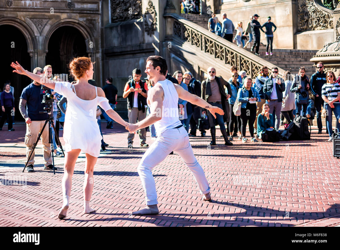New York City, USA - October 28, 2017: Manhattan NYC Central park at Bethesda Arcade terrace couple of dancers in white clothing young millennials fil Stock Photo