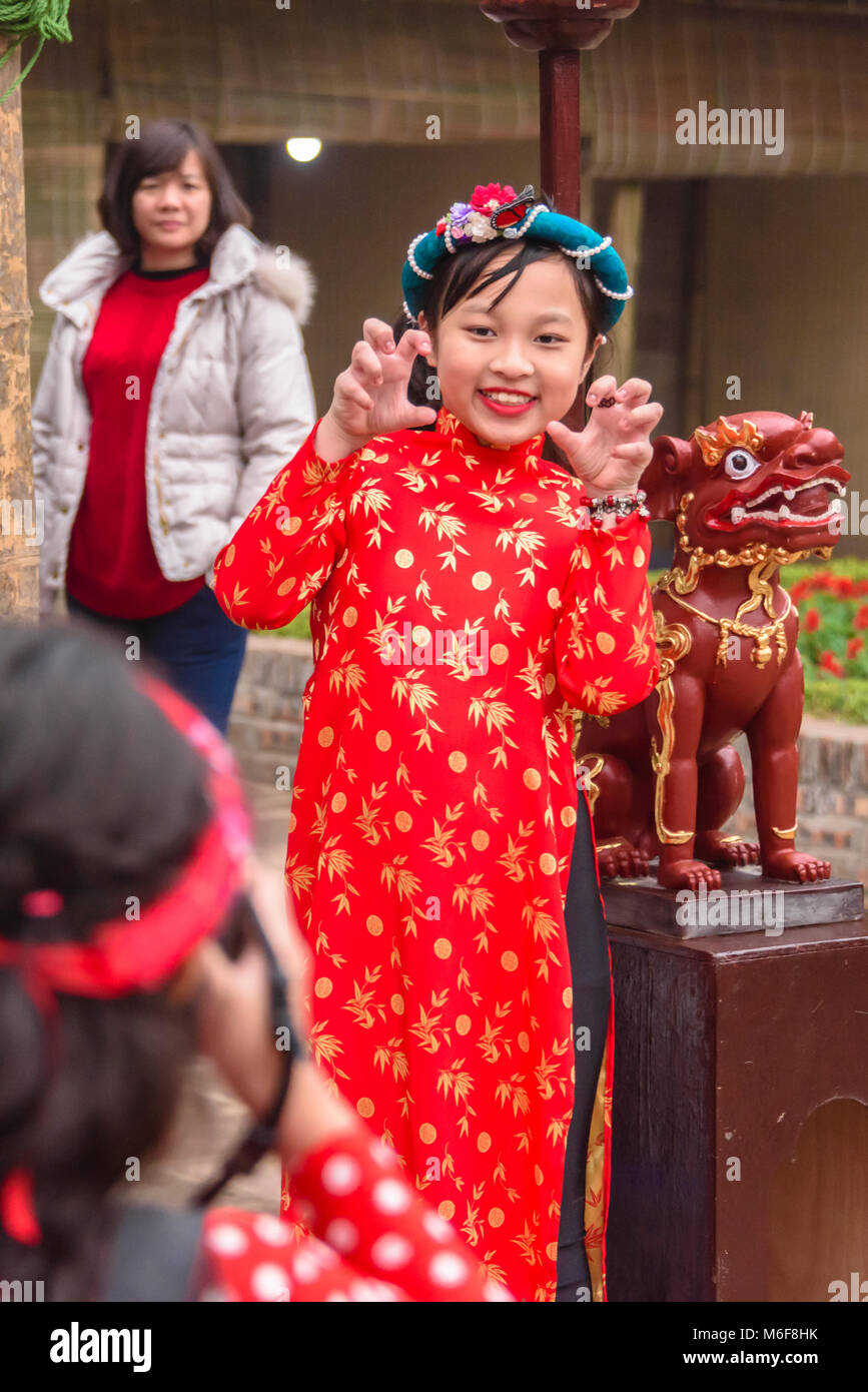 A young girl has her photograph taken as she celebrates the Chinese New Year of the dog in Hanoi, Vietnam Stock Photo