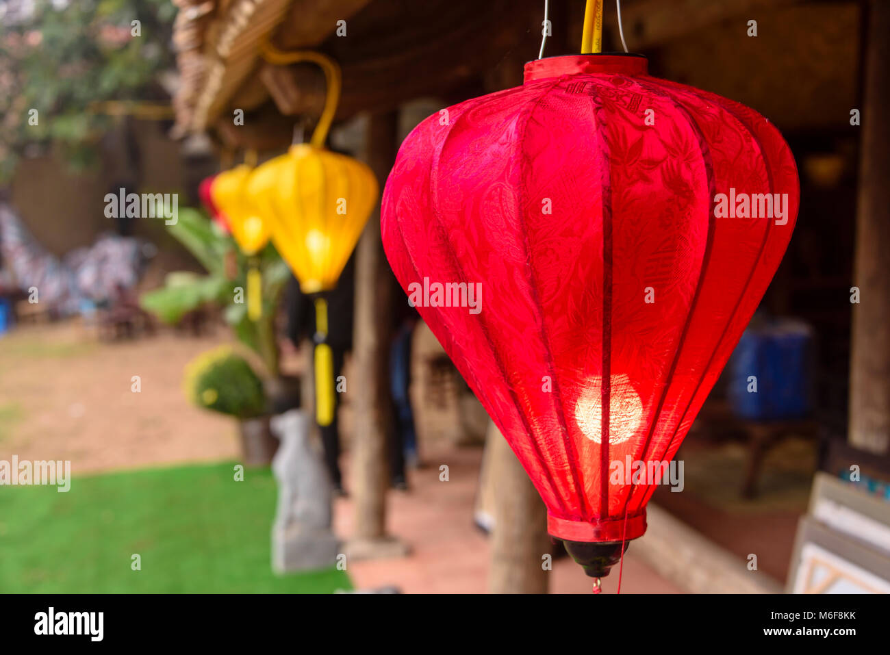 Chinese lanterns outside a traditional wooden building in Hanoi, Vietnam, to celebrate the Chinese New Year. Stock Photo