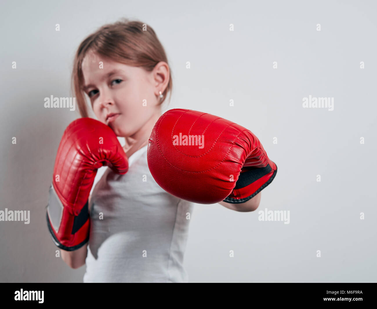 little girl in Boxing gloves on white background Stock Photo Alamy