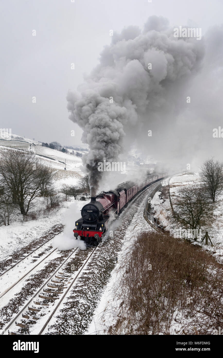 Lancashire, UK. 3rd March 2018. In a Wintery landscape, steam locomotive 'Galatea' hauls 'The Pennine Limited' special train up Copy Pit incline, near Burnley, Lancashire. The combination of cold weather and the steep gradient produce an impressive amount of smoke and steam from the locomotive. The trip went from Carnforth (Lancashire) to Preston, Manchester, Sheffield, Wakefield, and Blackburn before returning to Carnforth. Credit: John Bentley/Alamy Live News Stock Photo
