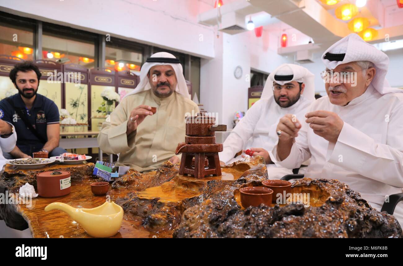 Kuwait City, Kuwait. 3rd Mar, 2018. Kuwaitis taste Chinese tea at the Chinese Center in Kuwait City, capital of Kuwait, on March 3, 2018. Kuwait opened a Chinese center in Kuwait City on Saturday to promote cultural exchanges and deepen economic and trade cooperation. Credit: Nie Yunpeng/Xinhua/Alamy Live News Stock Photo
