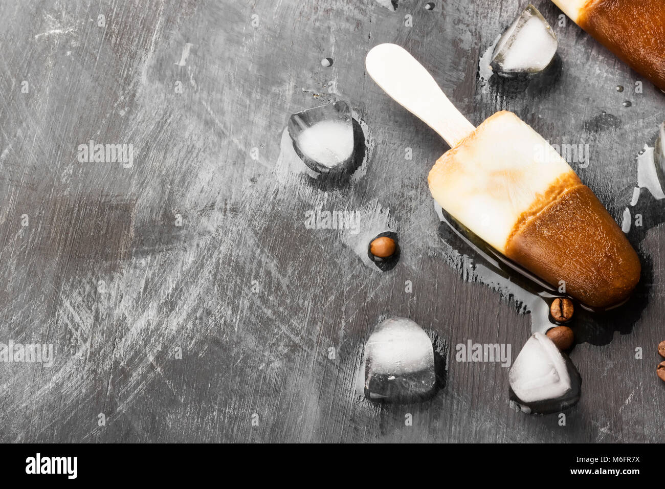 Coffee ice cream popsicles on a dark background. Copy space. Food