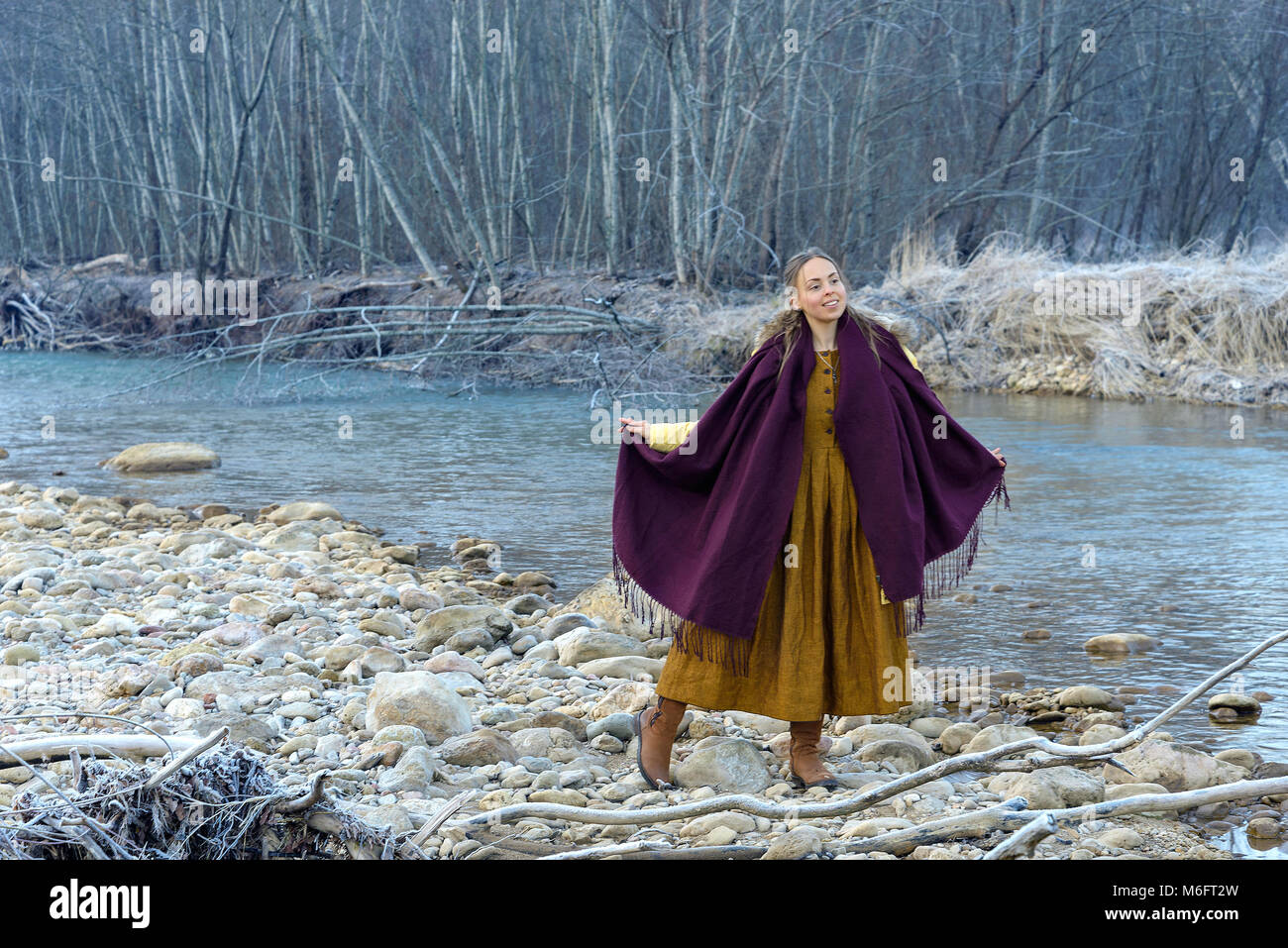 Model posing against the backdrop of a mountain river Stock Photo