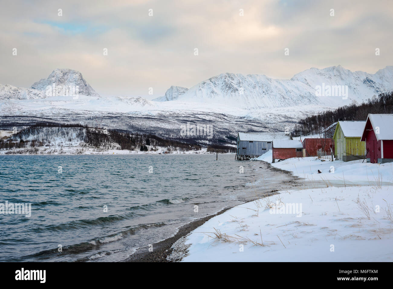 NORWAY, SJURSNES ( TROMSO ) - MARCH 3, 2018: Typical arctic winter in fishing village under Lyngen Alps Stock Photo