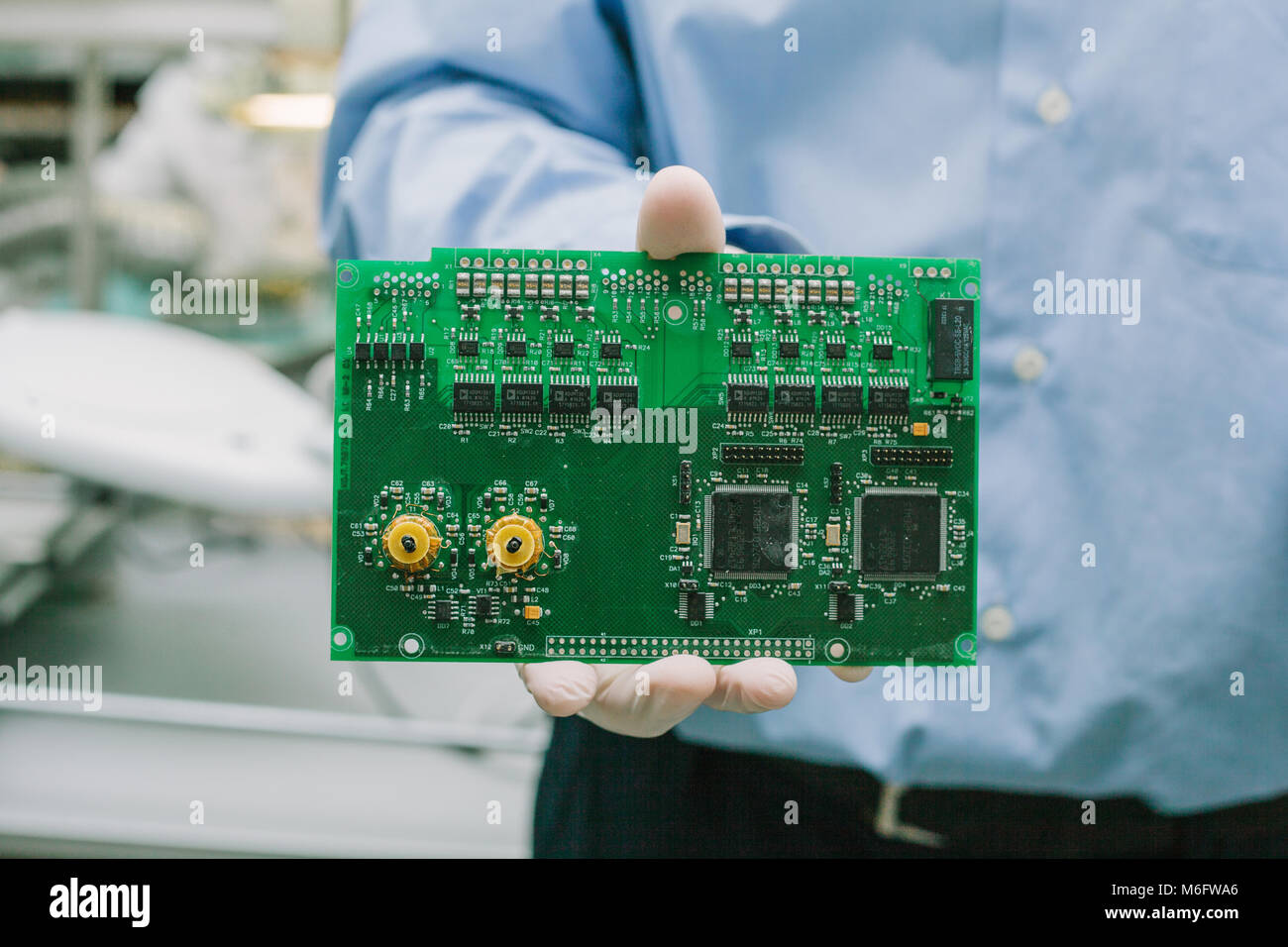 Technician with computer circuit board with chips. Spare parts and