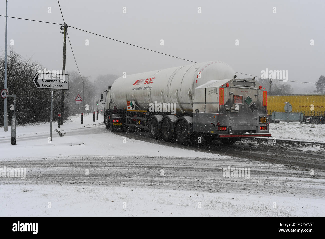 A BOC tanker carrying dangerous cargo on a snow covered A36 in treacherous conditions after snow storm. Stock Photo