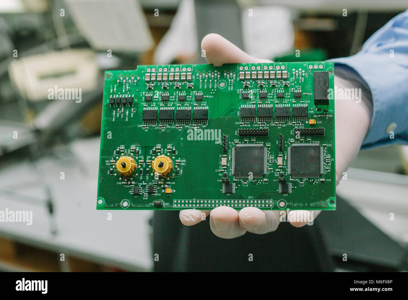 Technician with computer circuit board with chips. Spare parts and