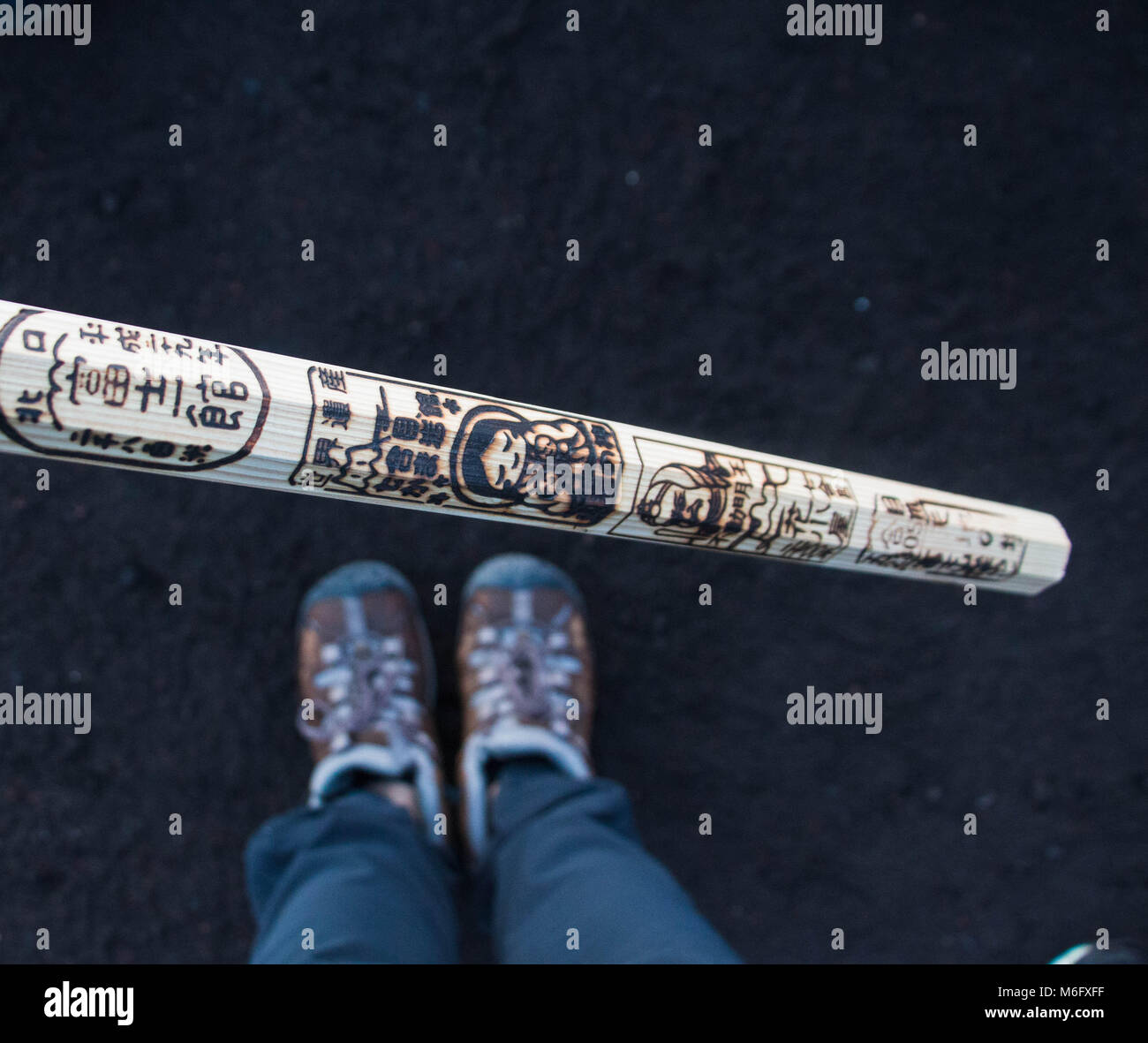 Hiking shoes and the stick collected on the hike up mount fuji Stock