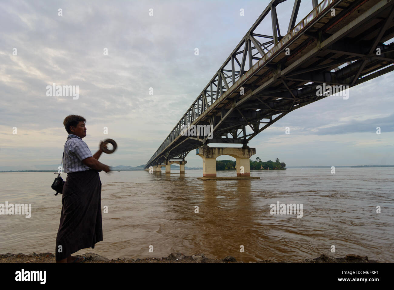 Mawlamyine (Mawlamyaing, Moulmein): Thanlwin Bridge, Thanlwin (Salween) River, road and railway bridge, man fishing, , Mon State, Myanmar (Burma) Stock Photo