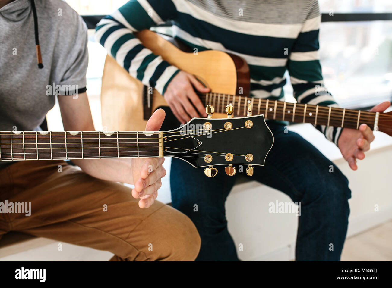 Learning to play the guitar. Music education. Stock Photo