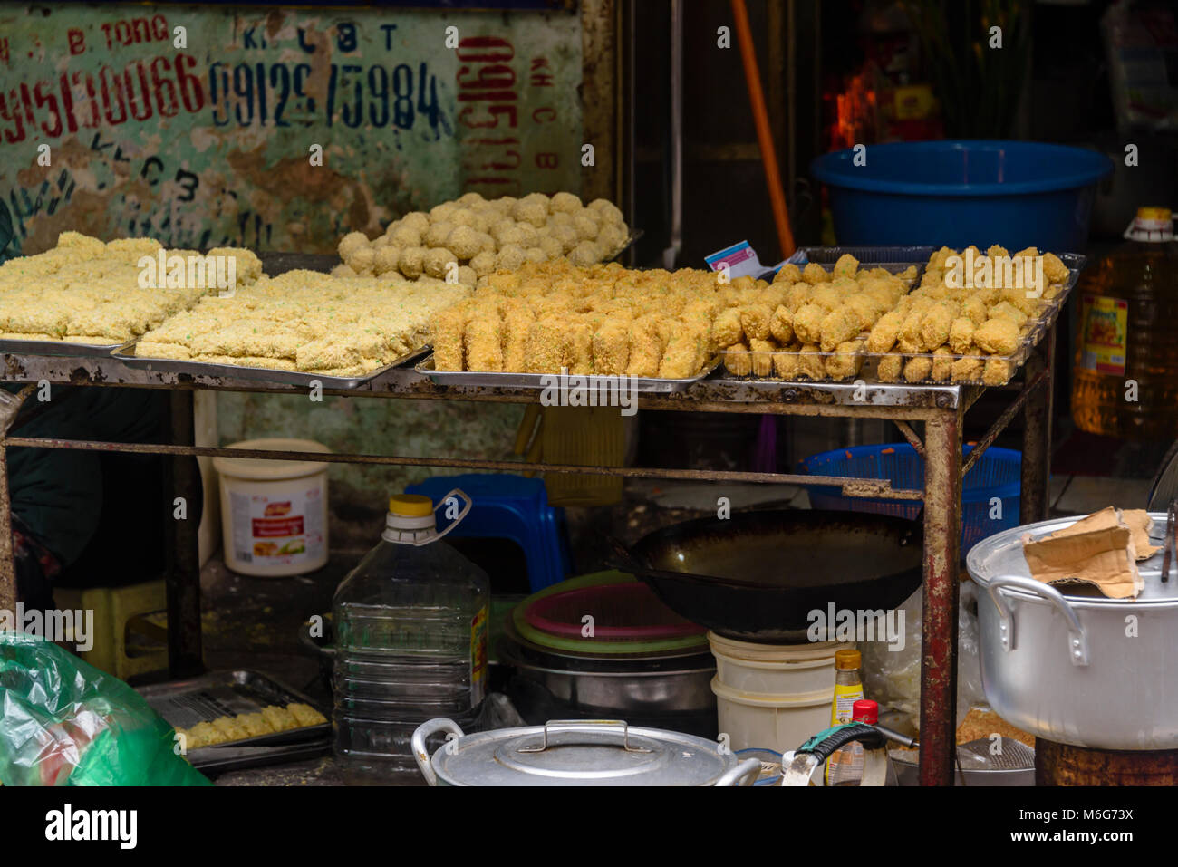 Street taro for sale, snacks which contain boiled quails eggs, pork or beef, wrapped in flour and potato, and deep fried. in Hanoi, Vietnam Stock Photo
