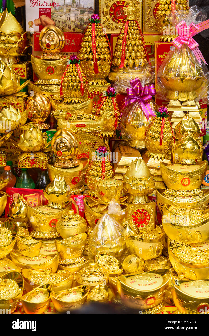 Gold coloured gifts for sale to celebrate the Chinese New Year in Hanoi, Vietnam Stock Photo