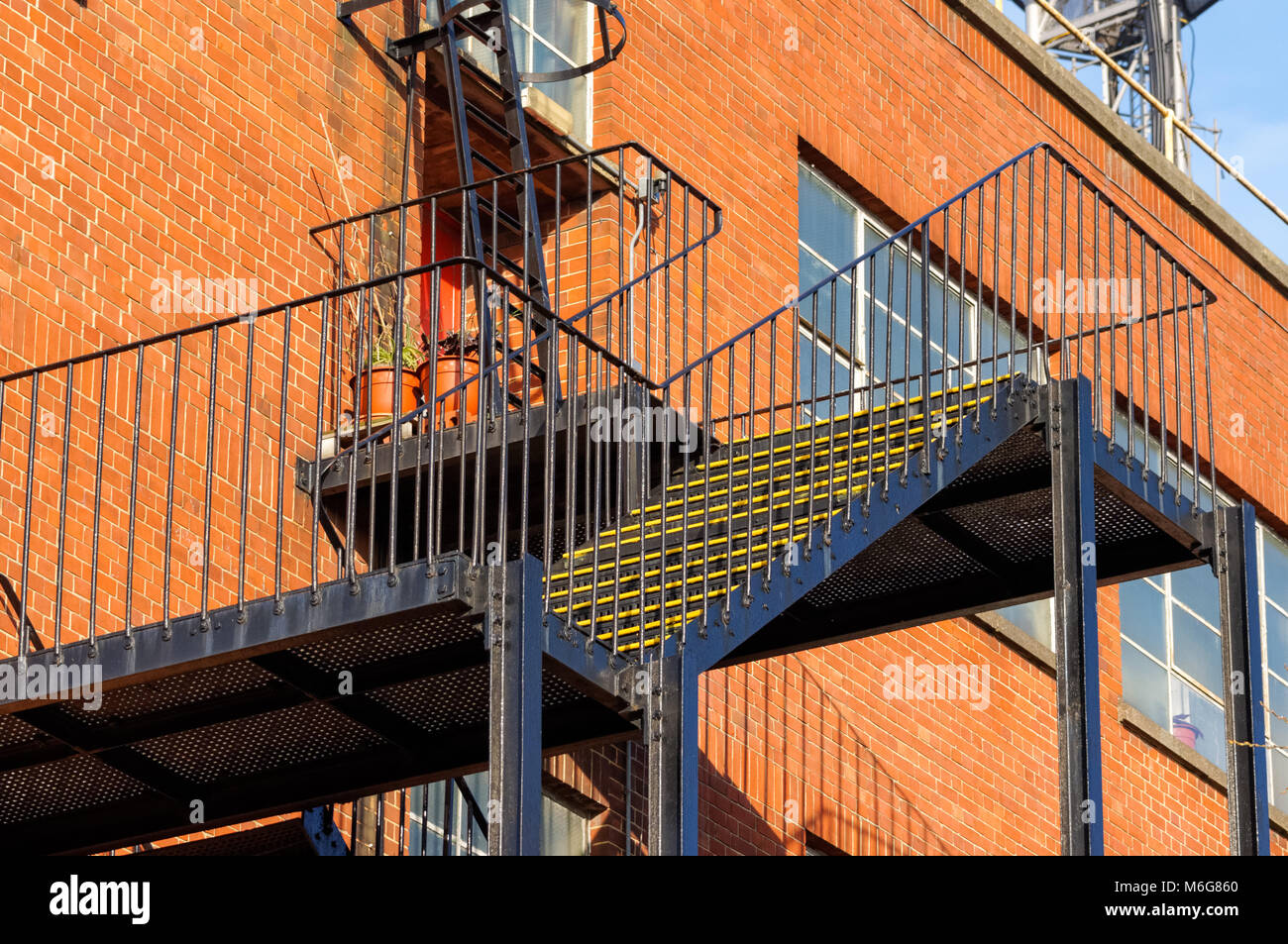 Fire escape staircase on side of industrial brick building, London, England, United Kingdom, UK Stock Photo