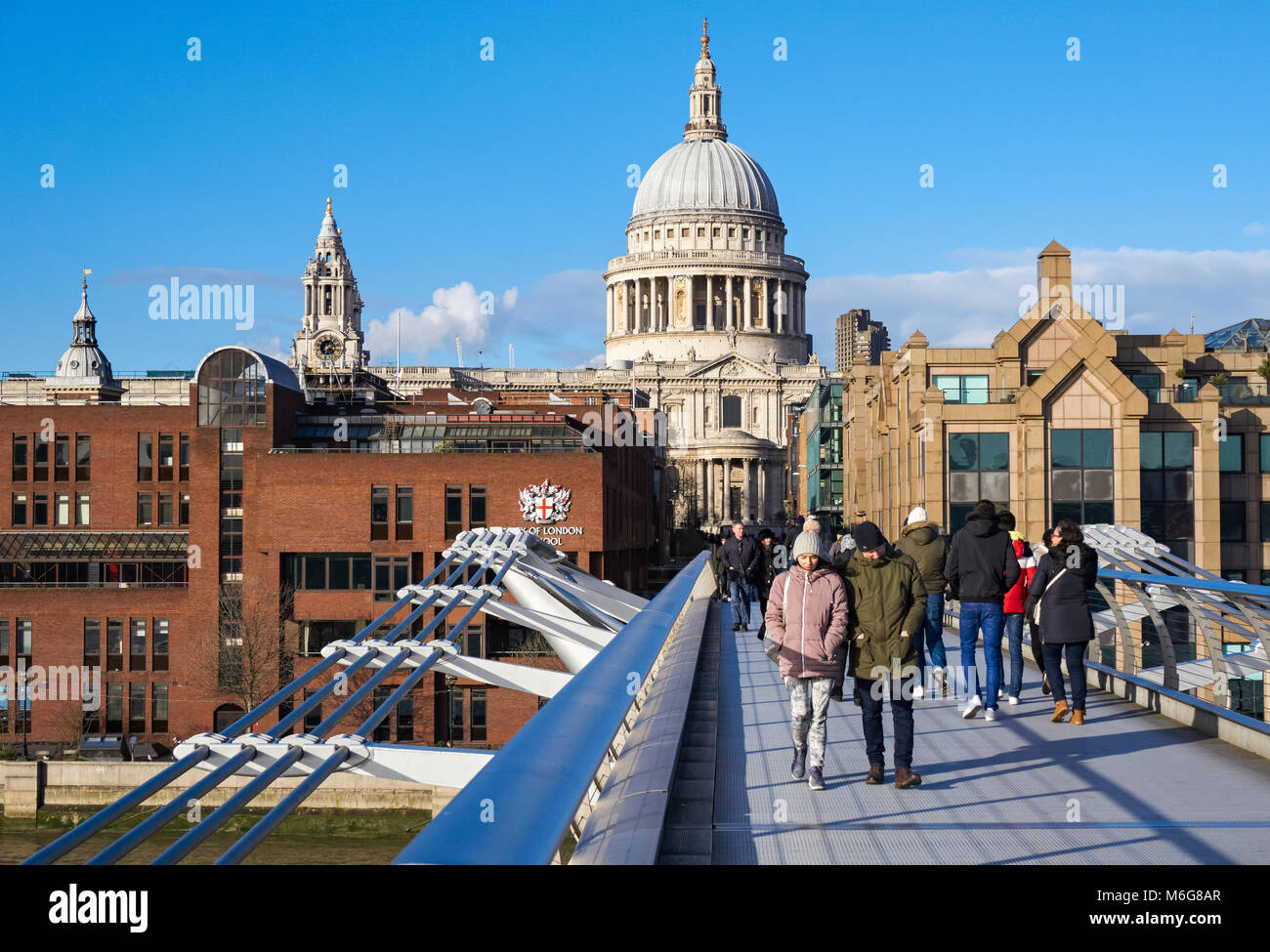 People on the Millennium Bridge with St Paul's Cathedral in the background, London England United Kingdom UK Stock Photo