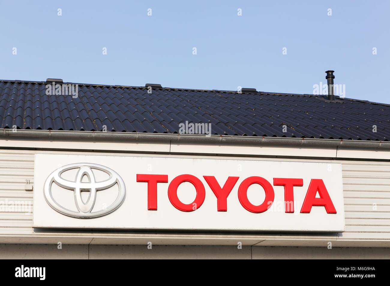 Logstor, Denmark - August 23, 2017: Toyota logo on a facade. Toyota Motor Corporation is a Japanese automotive manufacturer Stock Photo