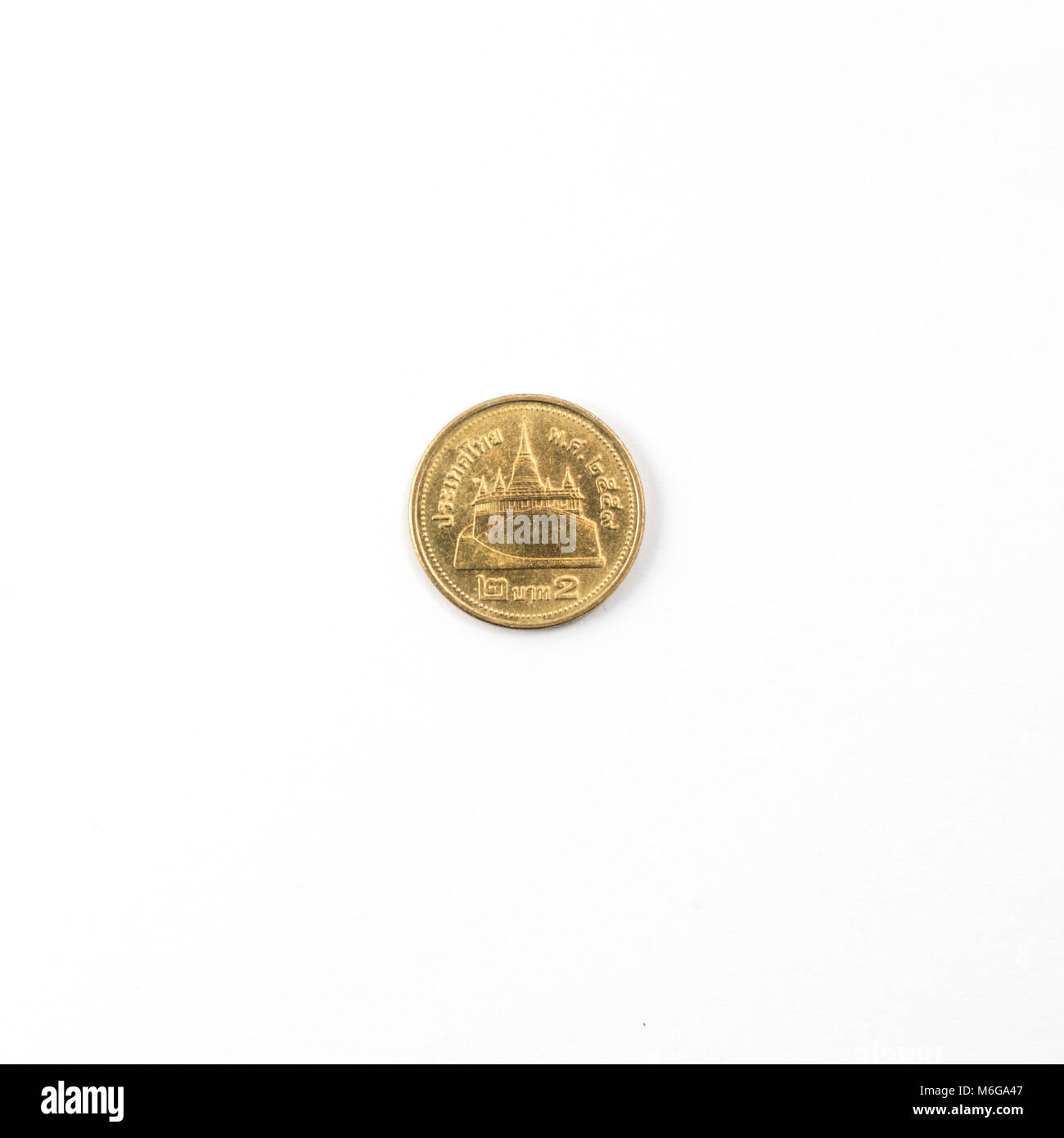 Thai coin from 2 Bath on a white surface Stock Photo