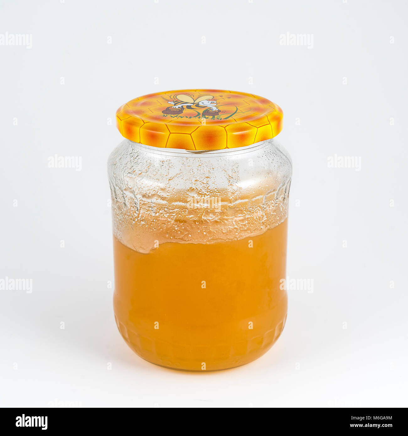 Jar of nuts in honey isolated on white background Stock Photo