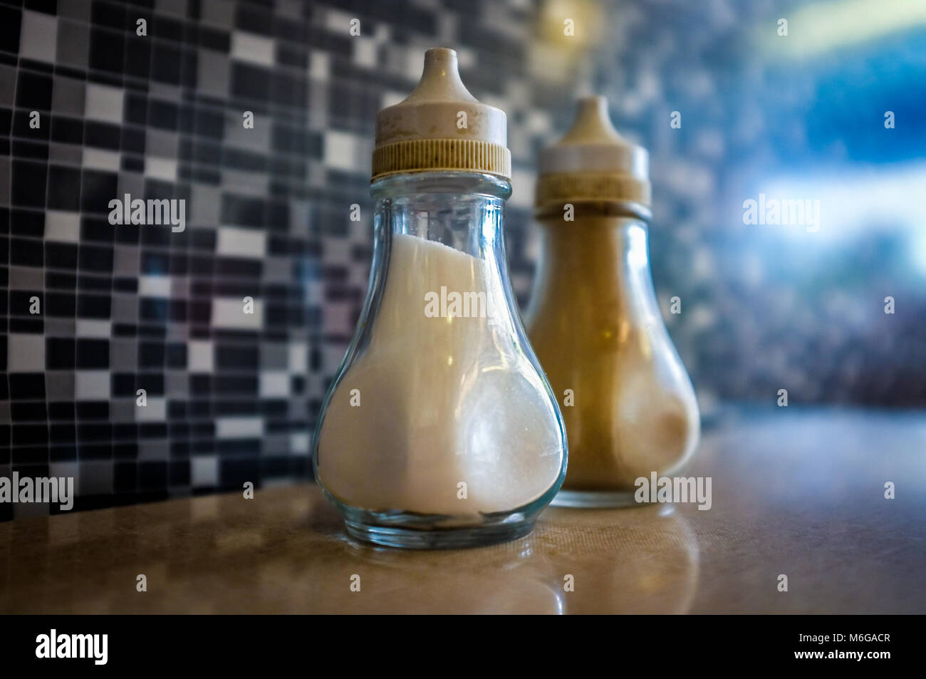 Classic retro salt & pepper Pots on a table in a cafe. Stock Photo