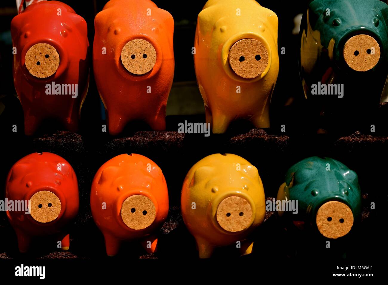 Multicolored ceramic piggy banks with corked noses Stock Photo