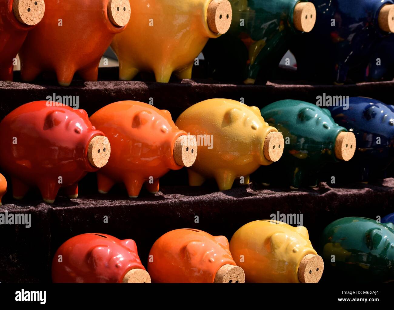 Multicolored ceramic piggy banks with corked noses Stock Photo