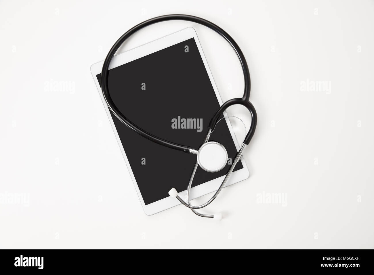 Digital Tablet And Stethoscope On White Table Stock Photo - Alamy