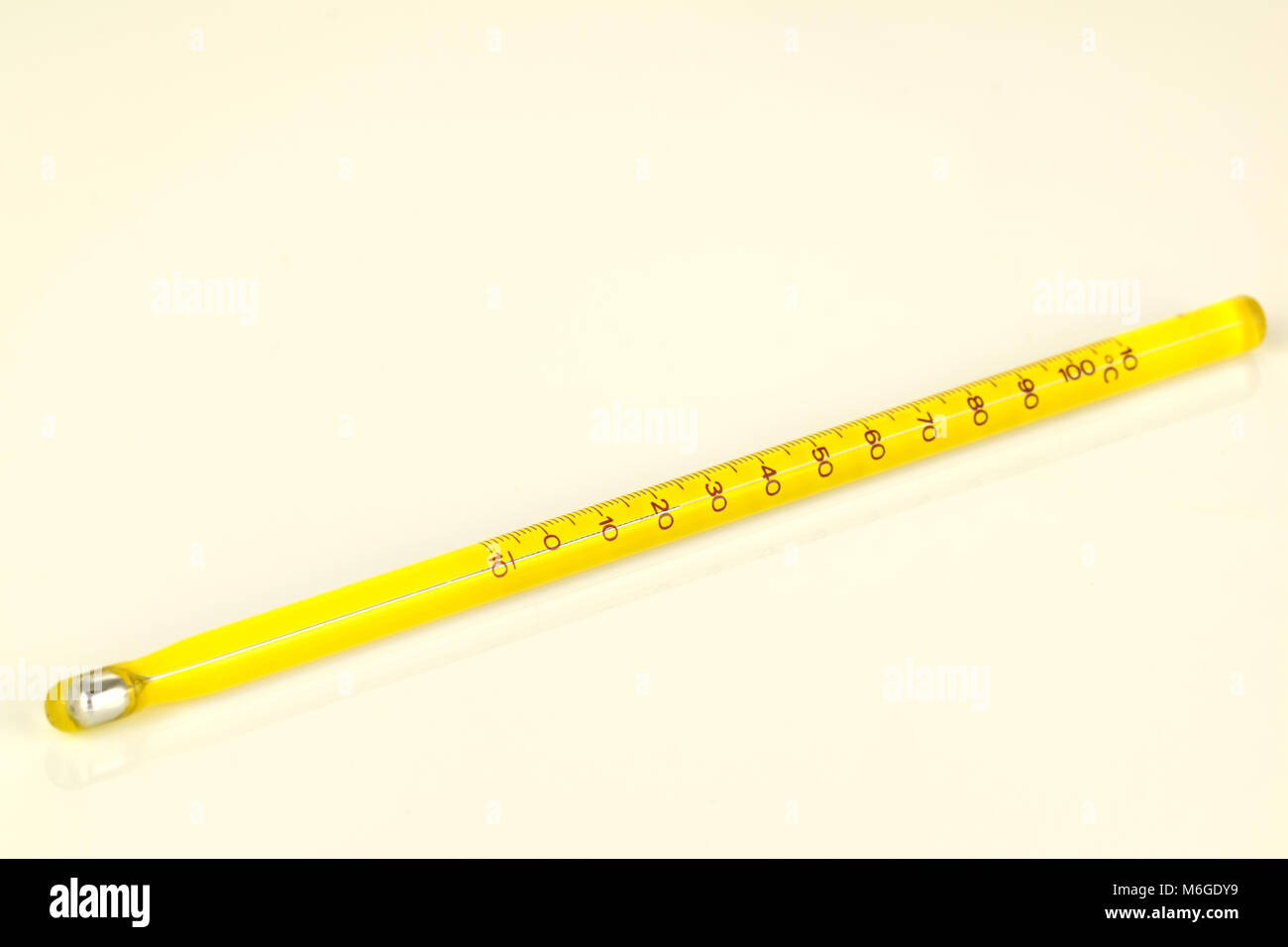 yellow mercury thermometer isolated on a white background. Scientific medical measuring device