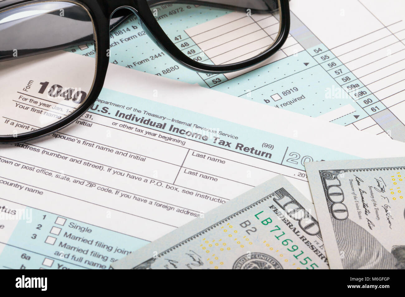 USA Tax Form 1040 with 100 USA dollar bills and glasses Stock Photo - Alamy