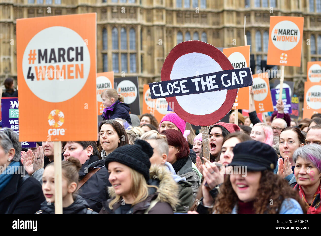 Marchers gather outside the Palace of Westminster, central London ahead of the March4Women. Stock Photo