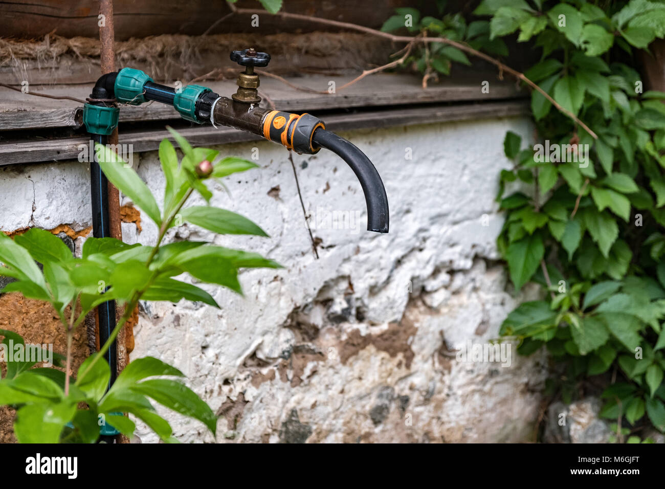 Outdoor faucet for irrigation system in a village. Rural scene Stock Photo