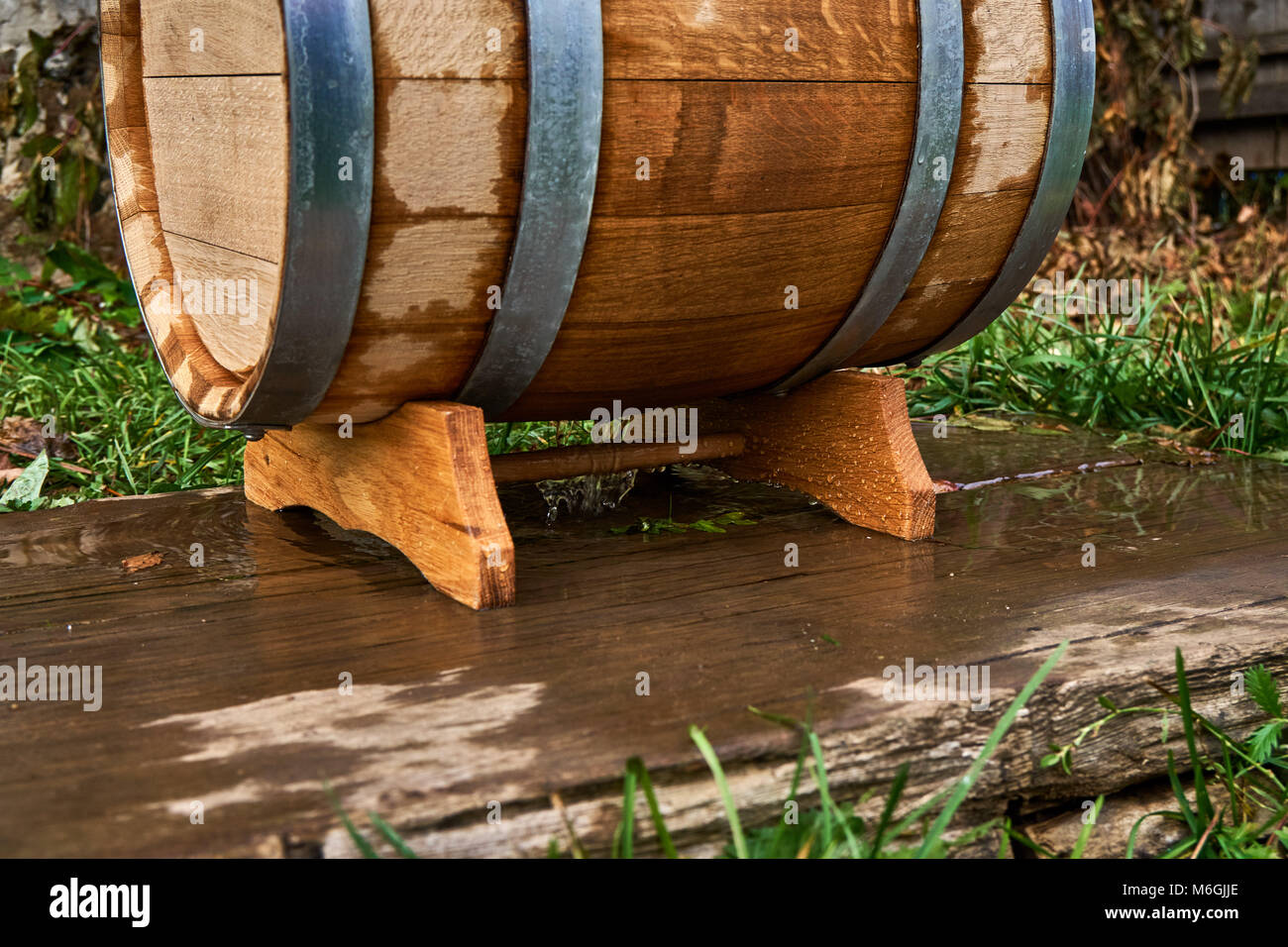 Old oak barrel for storing wine stands on a special stand during