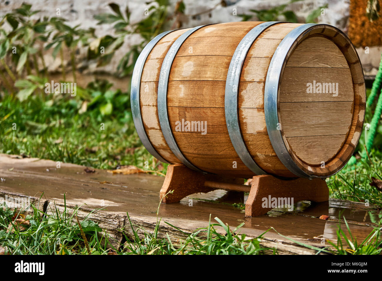 Old oak barrel for storing wine stands on a special stand during