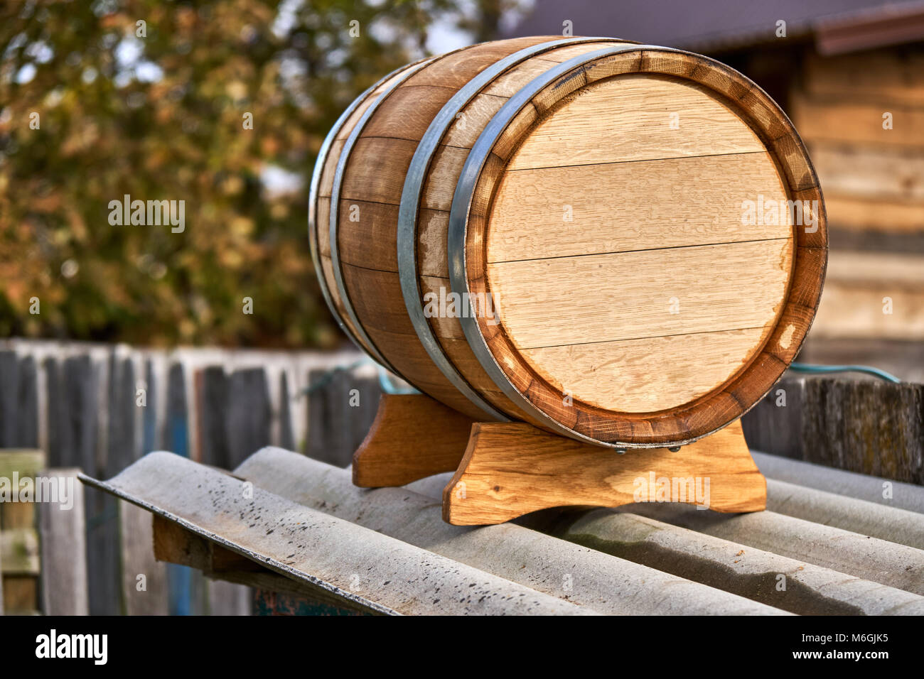 Old oak barrel for storing wine stands on a special stand in the